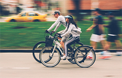 image of people riding bikes on a city street